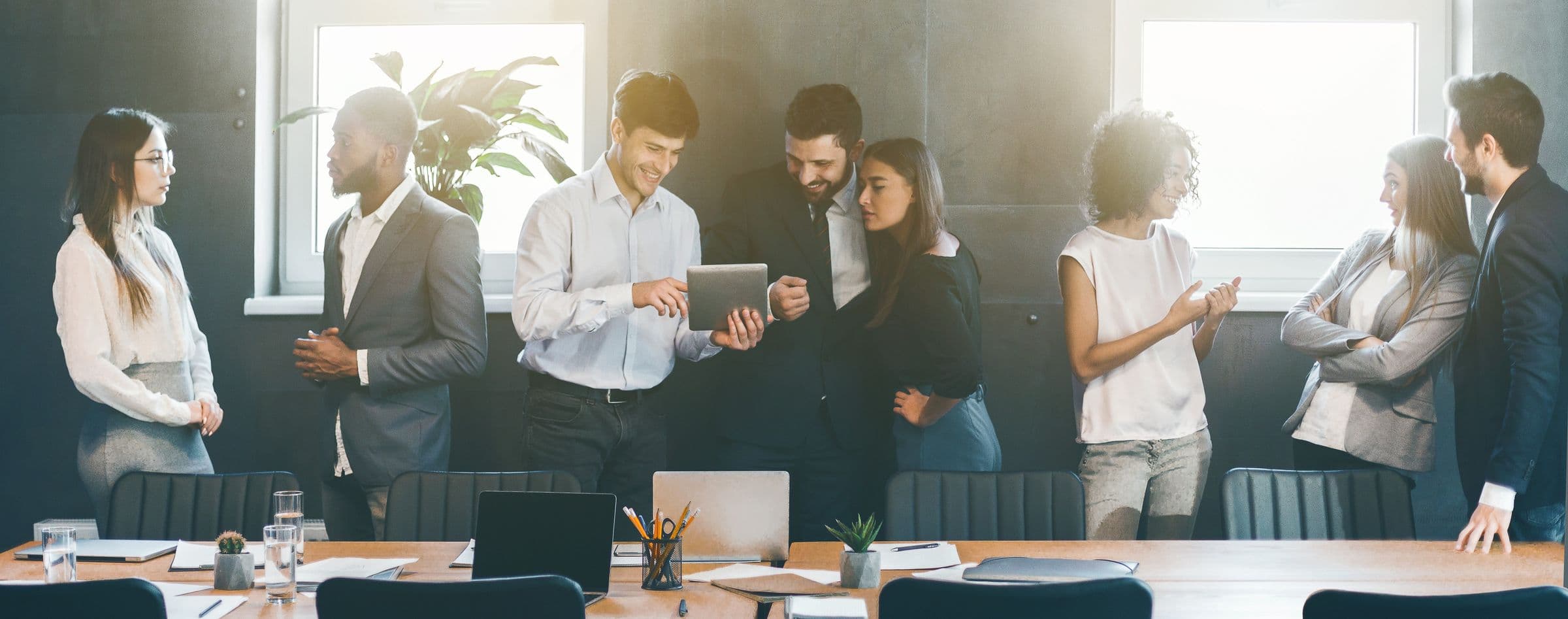 Business professionals gathered around a conference table in lively discussion at a New Life Networking event